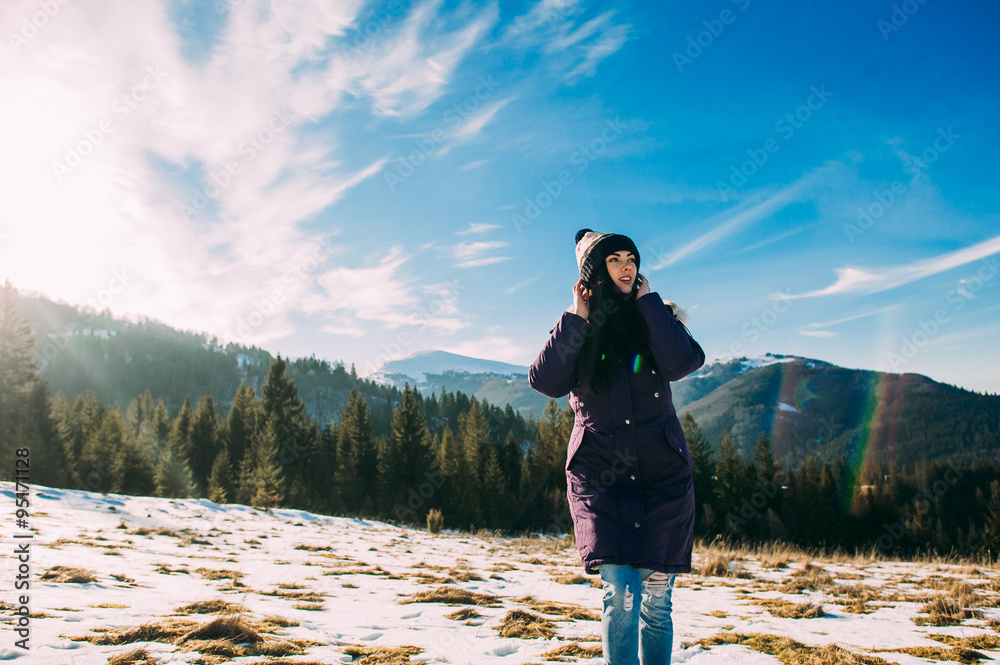 walk in the mountains, a beautiful girl on a background of snowy