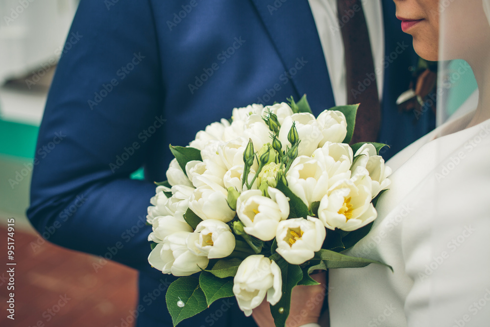 groom and bride holding beautiful white tulip bouquet groom and bride holding beautiful white tulip bouquet
