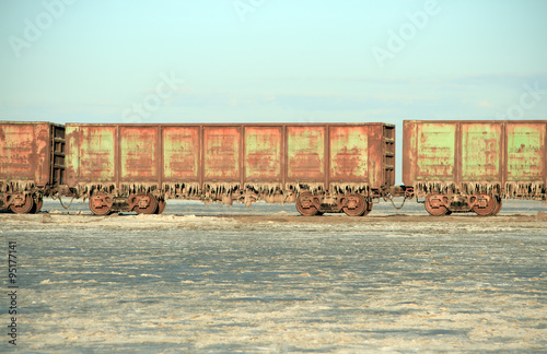 Old rusty train cars with stalactites of salt 
