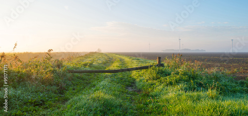 Tracks along a canal at sunrise in autumn