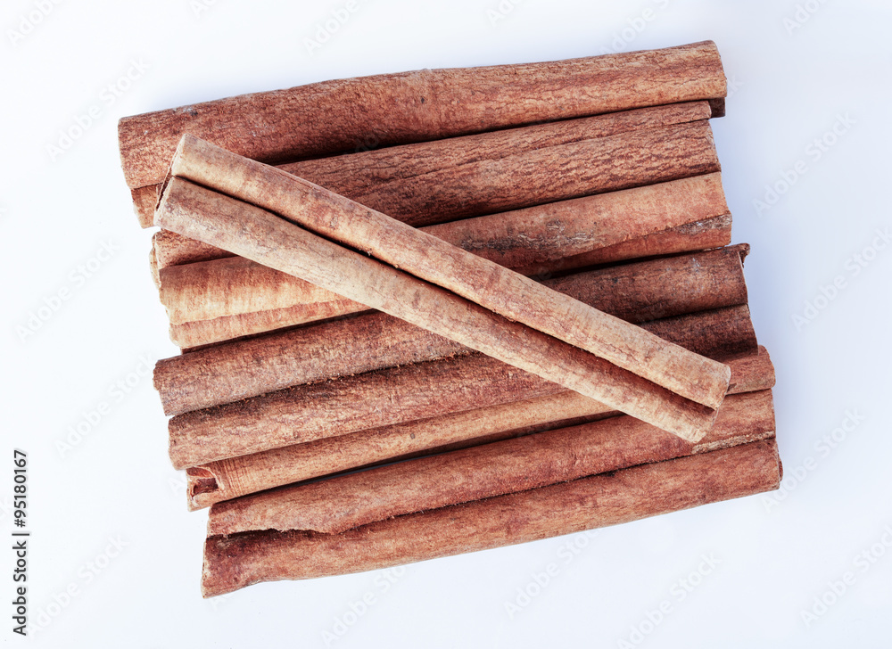 Cinnamon, spice, on a white surface, close-up. Cinnamon, spice, on a white surface, close-up.