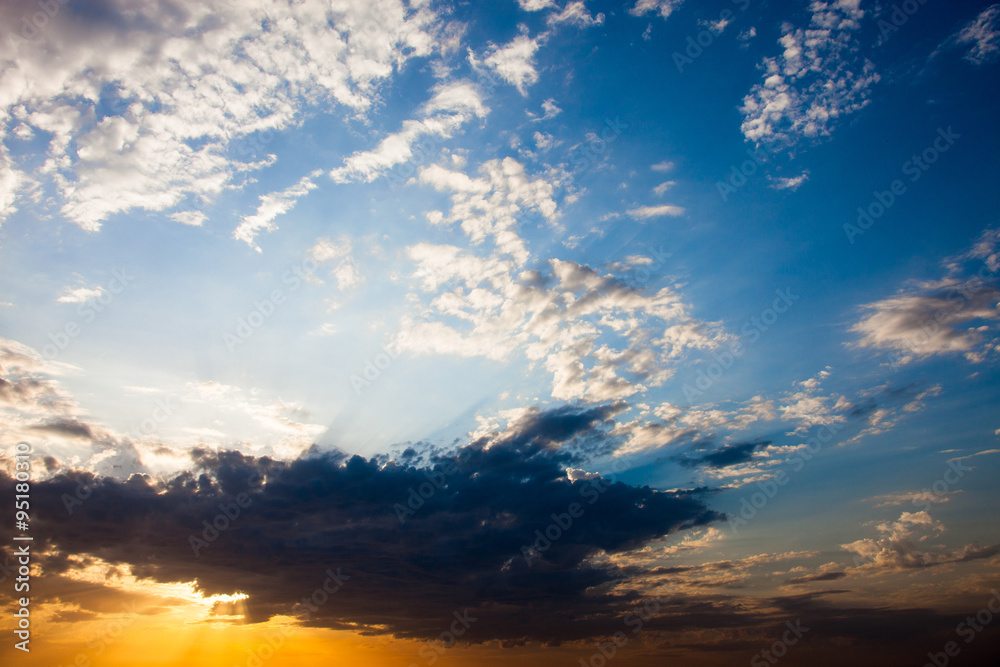 Cloudscape with the sun rays radiating from behind the cloud