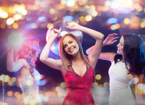 happy women dancing at night club