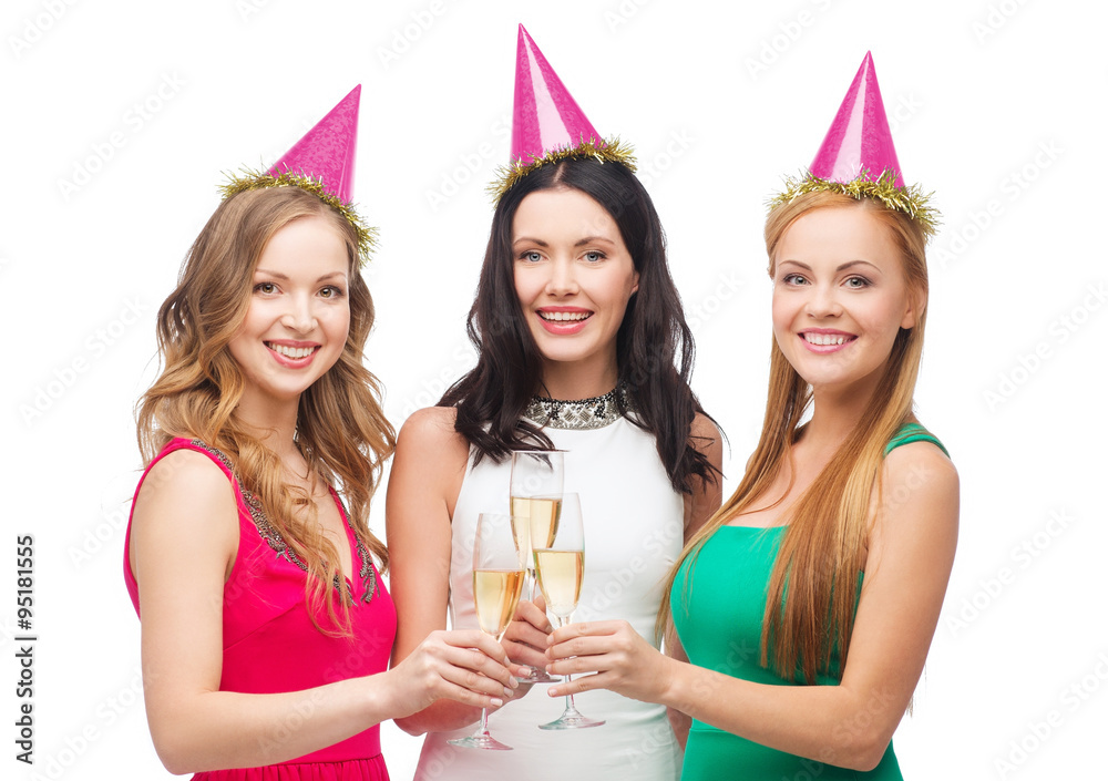 three women in pink hats with champagne glasses three women in pink hats with champagne glasses