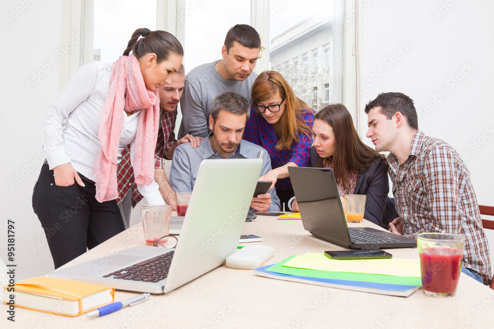 Young group of people discussing business plans. Young group of people discussing business plans.