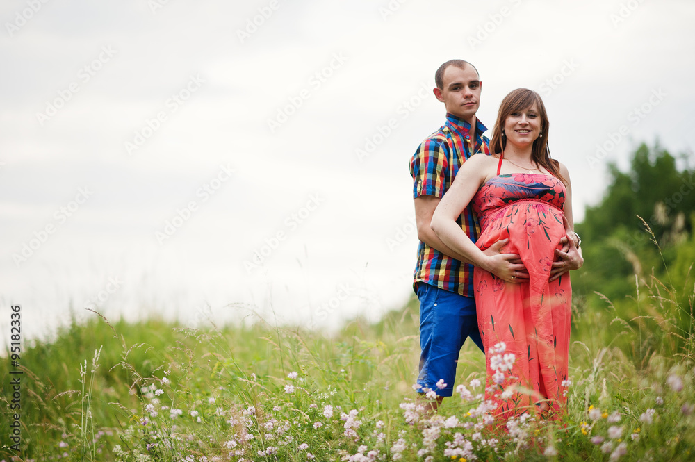 Fototapeta premium Happy young couple expecting baby, pregnant woman with husband