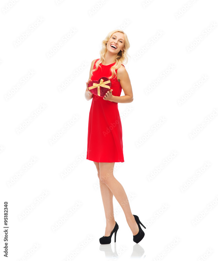 happy young woman holding heart shaped gift box happy young woman holding heart shaped gift box