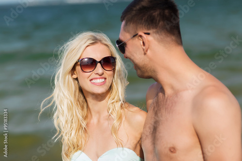 happy couple in swimwear walking on summer beach © Syda Productions