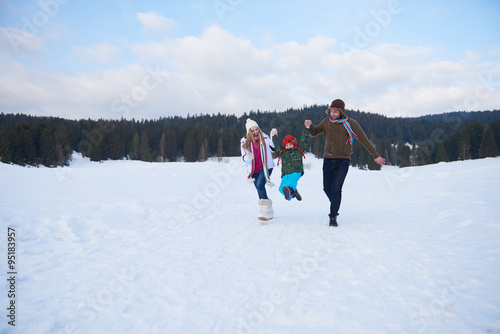 happy family playing together in snow at winter