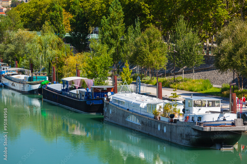 View of houseboats on the river in Lyon, France View of houseboats on the river in Lyon, France