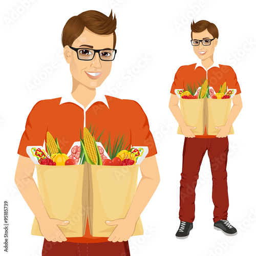 young man carrying grocery paper bags