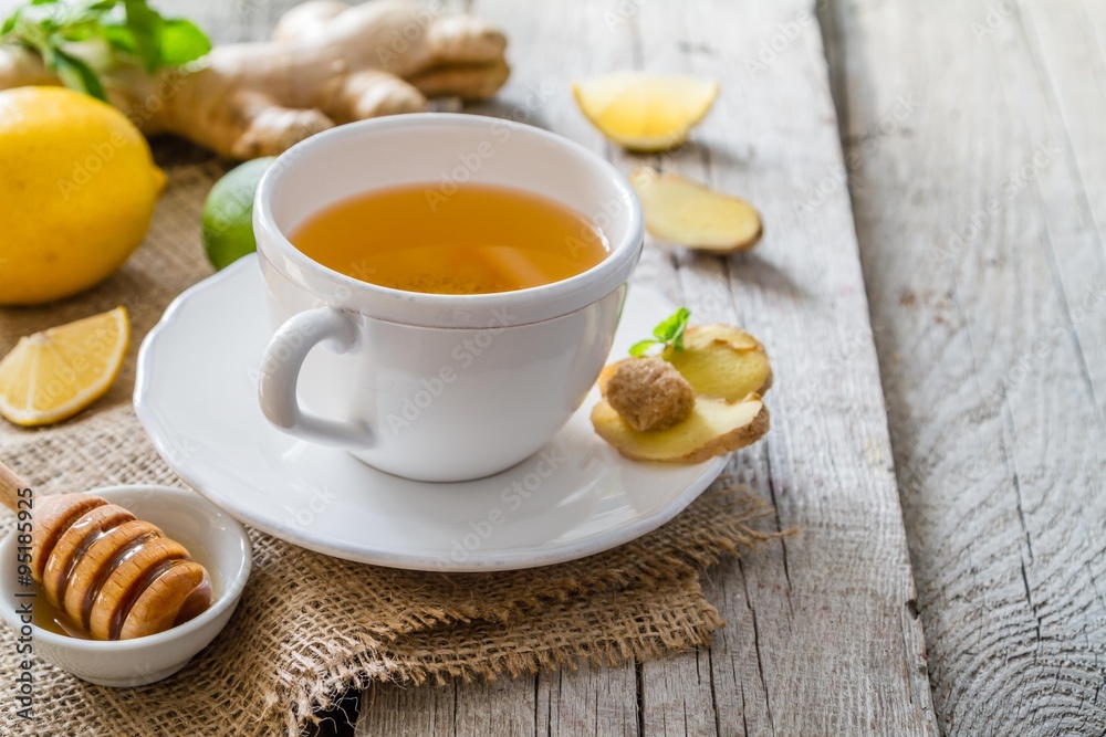 Ginger tea and ingredients on rustic wood background Ginger tea and ingredients on rustic wood background
