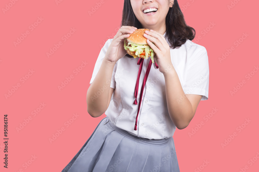 Asian girl eating hamburger