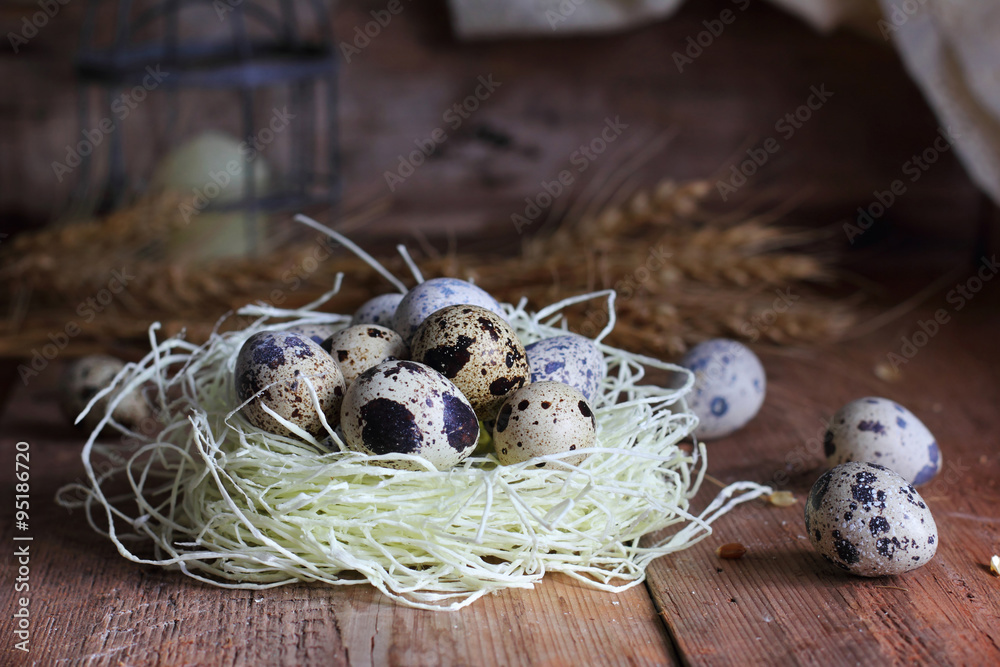 Quail eggs in a nest on a wooden background Quail eggs in a nest on a wooden background