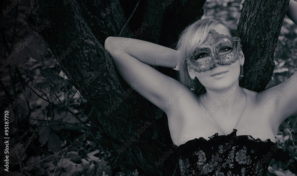 gorgeous blonde with carnival mask. Black and white photo