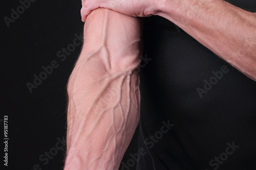 Bodybuilders hand with veins. Power, strong muscular athletic man, perfect body, hard work, male fitness motivation photo