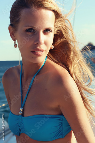 beautiful woman in swimsuit relaxing on yacht in open sea © dariyad
