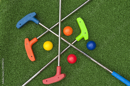 Four Mini Golf Putters and Balls