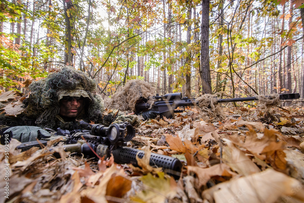 Camouflaged sniper lying in forest and aiming through his scope Stock Photo  by ©Nesterenko_Max 89112398