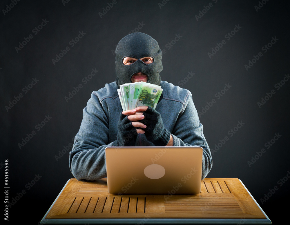 Happy cybercriminal man holding euro cash Happy cybercriminal man holding euro cash