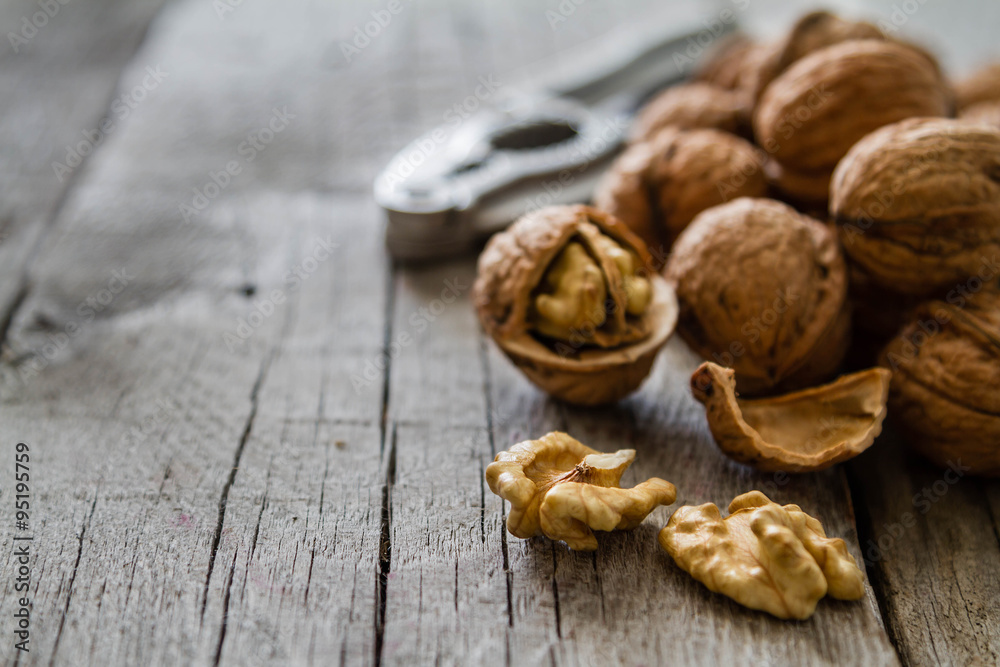 Whole walnuts on rustic background