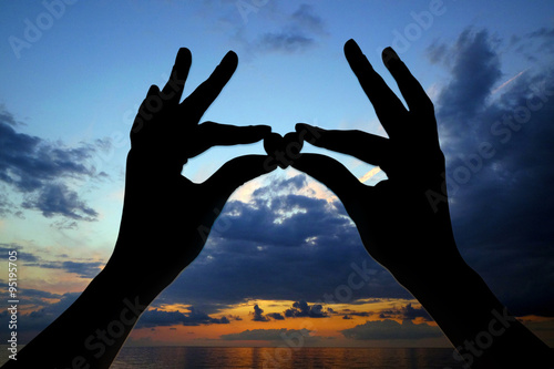 Silhouettes of hands with heart