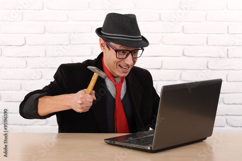 Εκτύπωση καμβά Furious angry man destroying his laptop with a hammer