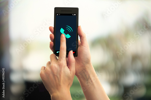 Hands holding mobile smart phone on abstract background