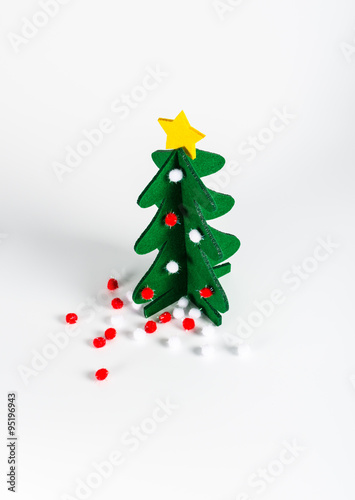 Small green Christmas tree with a golden star decoration isolate
