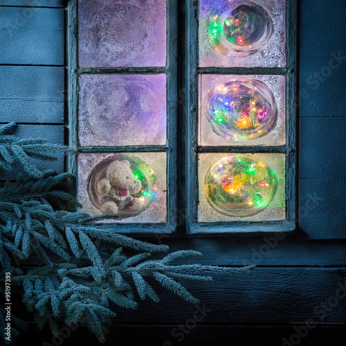 Gorgeous teddy bear for Christmas in frozen window