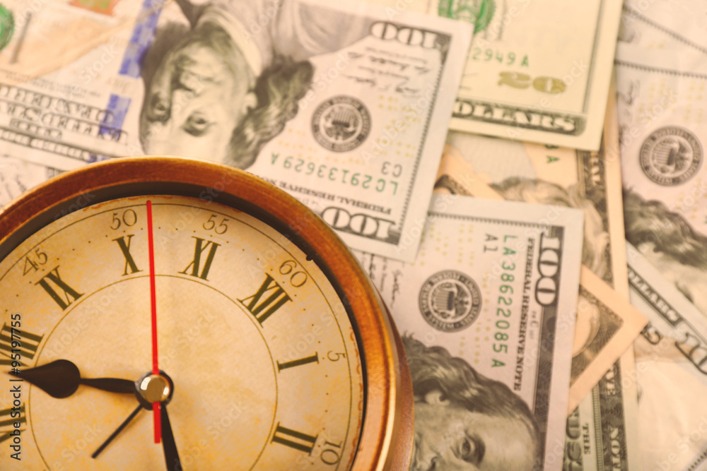 Money and alarm clock, closeup Money and alarm clock, closeup