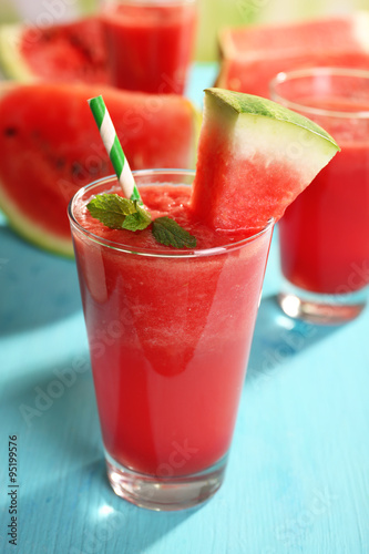 Glass of watermelon juice on wooden table, closeup