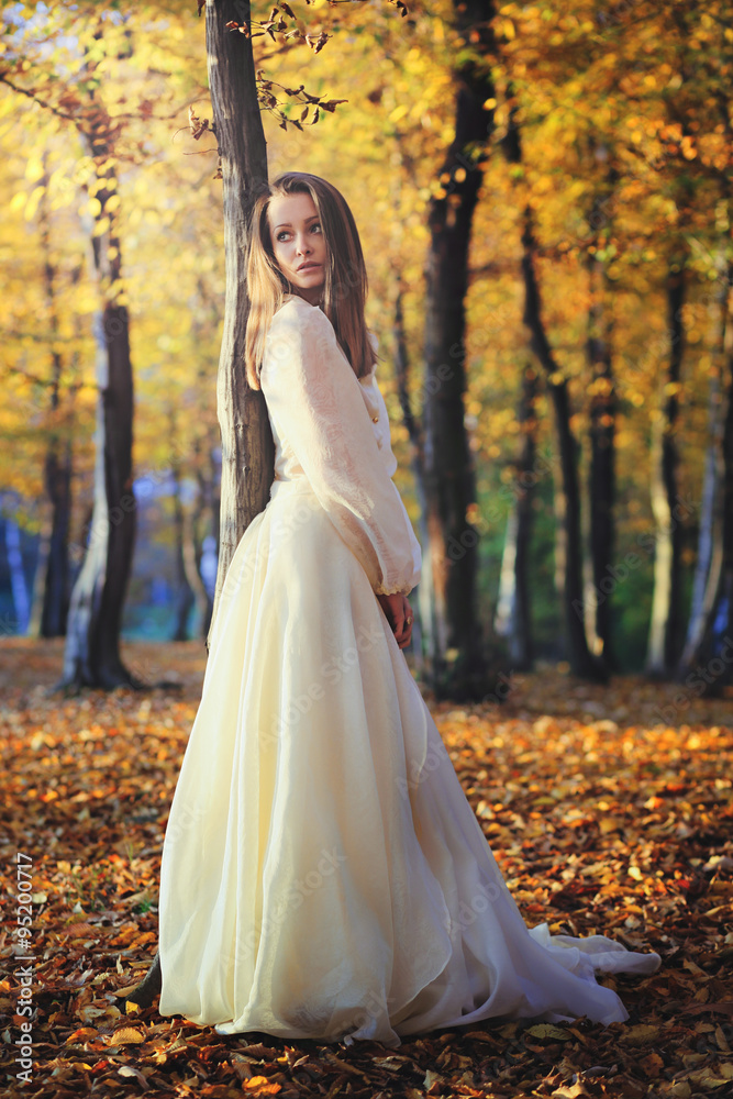 Beautiful woman posing in birch woods