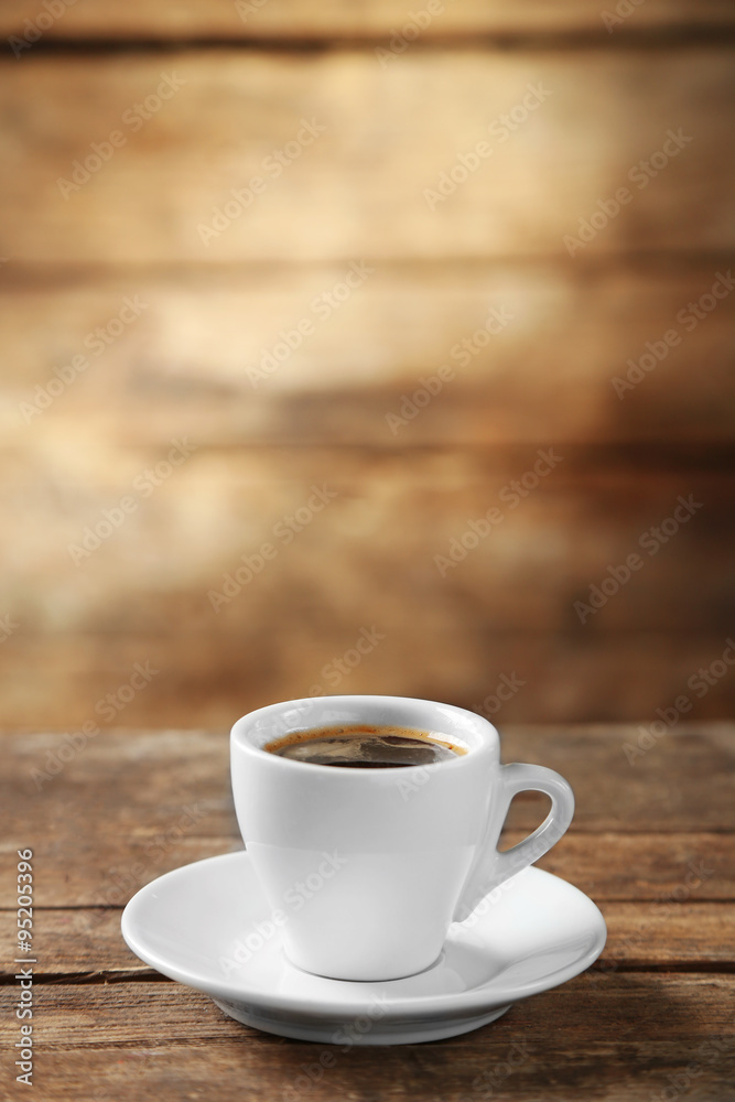 Cup of coffee and coffee grains on wooden background Cup of coffee and coffee grains on wooden background