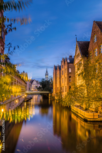 Obraz na płótnie Beautiful view of Lieve river with bridge and houses of bricks color in Ghent, F
