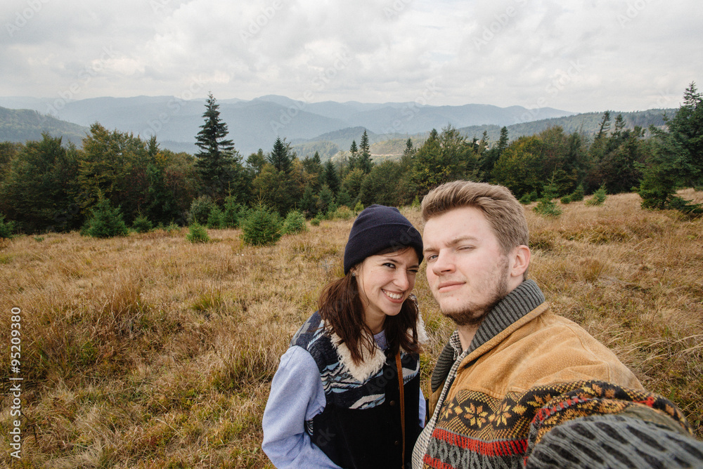 stylish beautiful traveling tender happy couple in the mountains