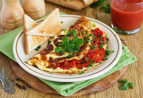 Breakfast omelet with tomatoes.