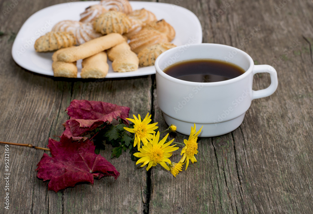 coffee, leaf, floret and plate with cookies behind, a still life coffee, leaf, floret and plate with cookies behind, a still life