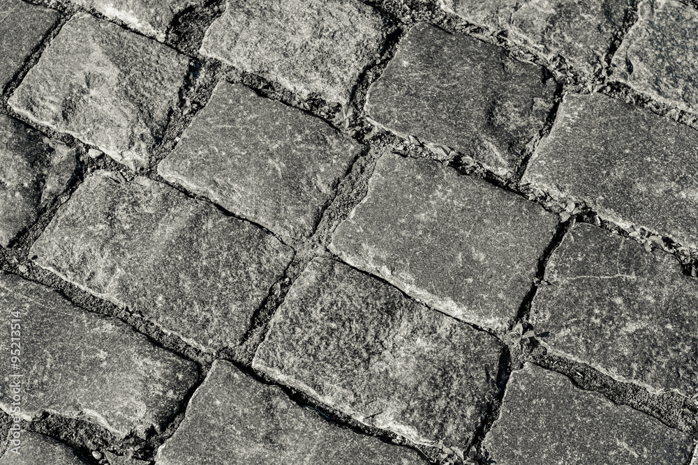 Obraz premium The road gently laid flat stones. Background.