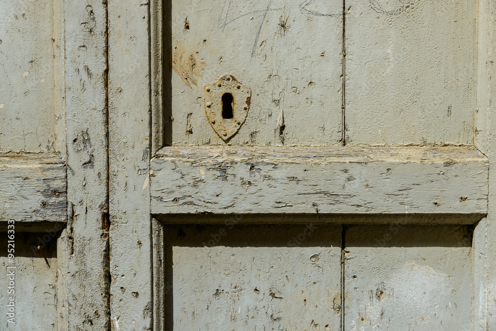 An old wooden door with a rusty lock. An old wooden door with a rusty lock.