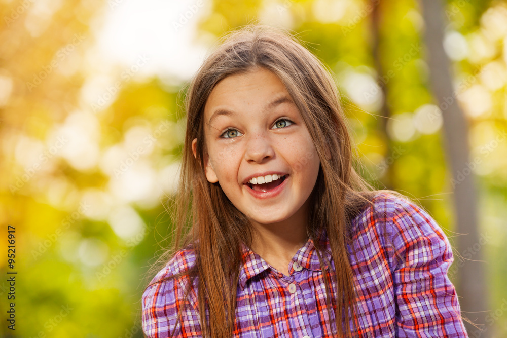 Little laughing girl portrait in autumn park