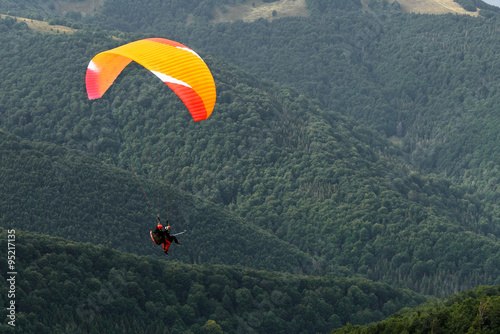 red yellow parachute in the mountains Summer