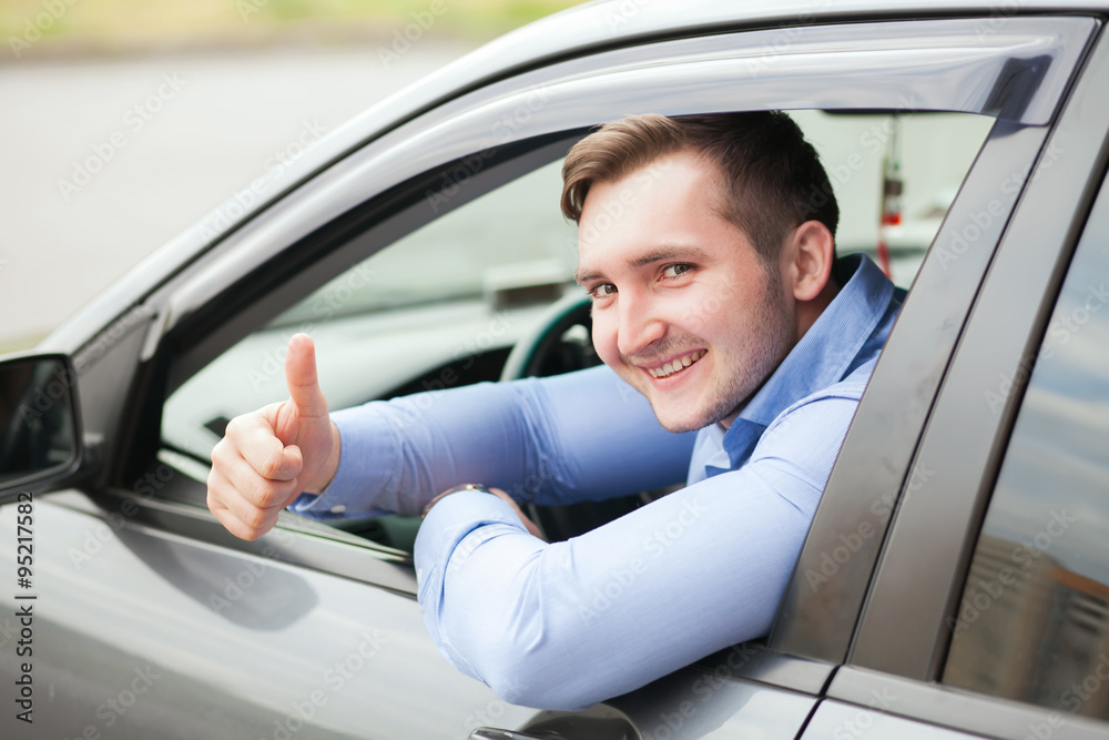Man doing thumbs up in car
