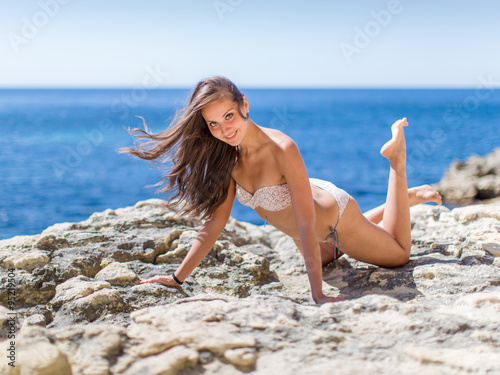 Girl on rocky seashore