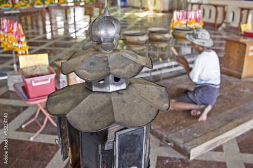 The oil lamp and oldman praying with joss stick and censer - thailand