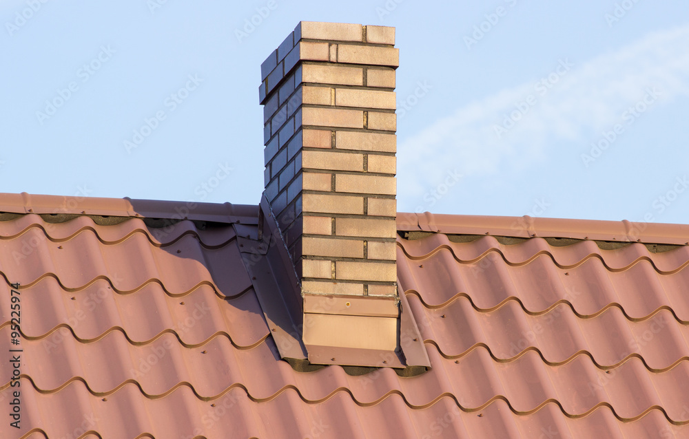 Brown chimney on roof of house on sunny day