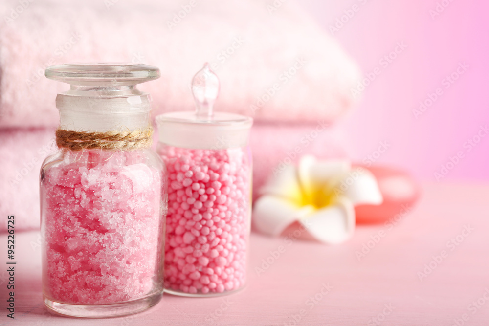 Spa treatment and flowers on wooden table, on light background Spa treatment and flowers on wooden table, on light background