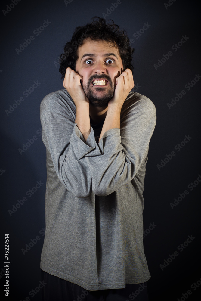 Young man in pajamas screaming to wake Young man in pajamas screaming to wake