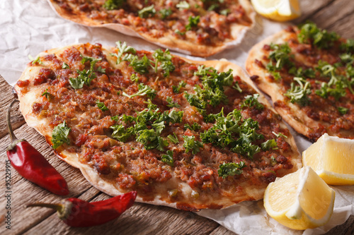 Wallpaper Mural Turkish pizza with meat - lahmacun macro on the table. Horizontal
 Torontodigital.ca