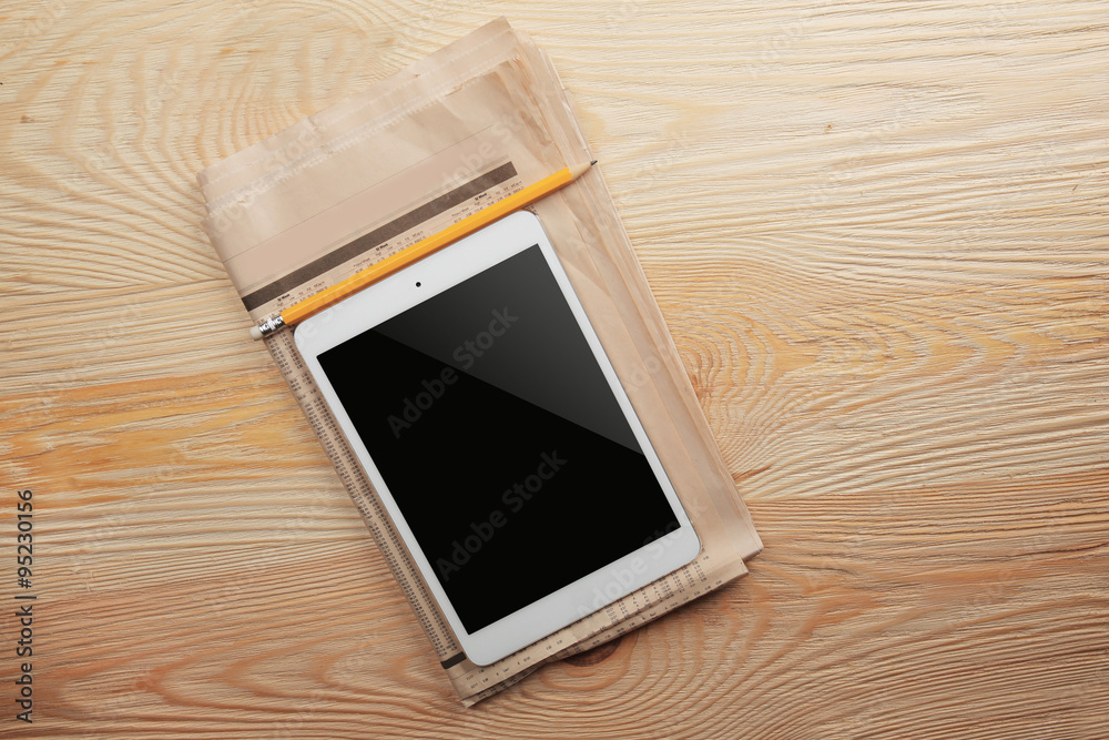 White tablet on wooden background White tablet on wooden background